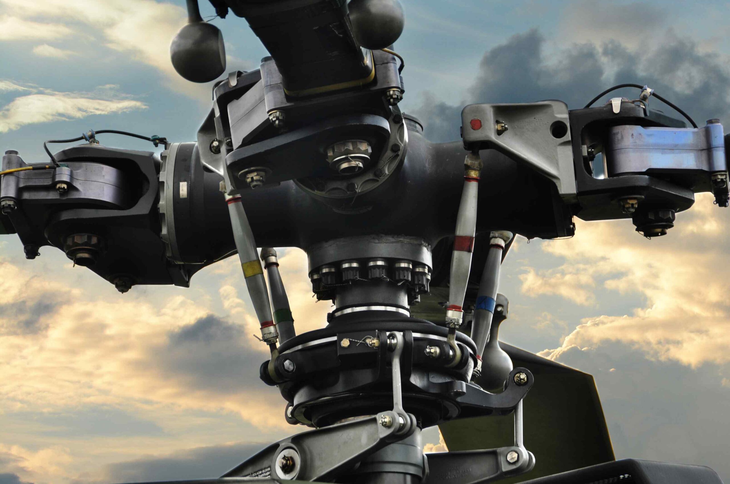 Helicopter main rotor head assembly showing hub, pitch links, and blade grips — AATECH spare parts procurement Southeast Asia